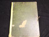 an old book with a map on it on a black cloth