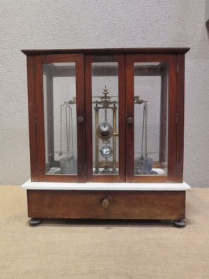 a small wooden case with a clock inside of it