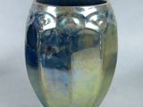a blue and green vase sitting on a white surface