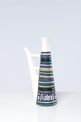 a white vase with a black and blue striped design