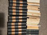 several books are stacked on top of each other on the floor