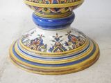 a blue and yellow vase sitting on top of a table