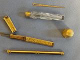 a gold fountain pen and some other items on a table