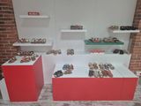 many pairs of shoes on display in a display case