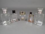 three small bottles of perfume sitting next to each other on a table