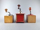 three different types of coffee grinders sitting on a table
