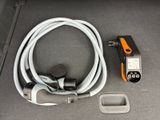 a cable connected to a car charger and a charger plugged into the trunk of a car