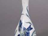 a blue and white vase with a bird on it