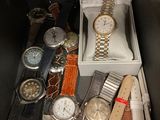 many different watches in a box on the table