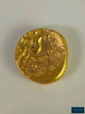 l'image d'une pièce d'or posée sur une surface blanche