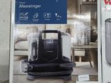 two boxes of vacuum cleaners sitting on a shelf