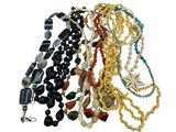 a lot of necklaces that are on a white surface