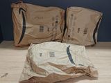 two bags of food sitting on the floor next to each other