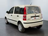 a small white car that is parked in a room