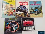 several books on a table with pictures of cars on them