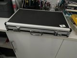 a laptop computer sitting on top of a metal case