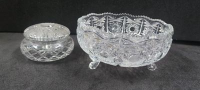 a glass bowl and a glass salt shaker on a table