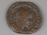 an old coin with a man ' s head on it on a white surface