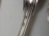 two spoons and a fork sitting on a table