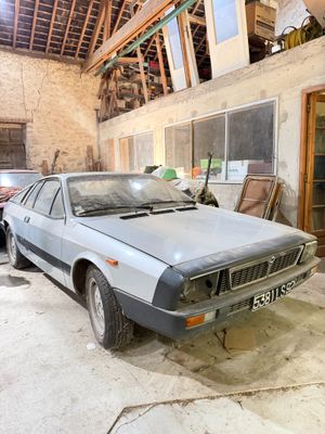 a car that is parked in a garage next to another car