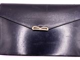 black leather envelope with a gold clasp on a white background