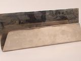 a silver metal business card holder on a white surface