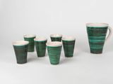 a set of six green and white cups and a pitcher