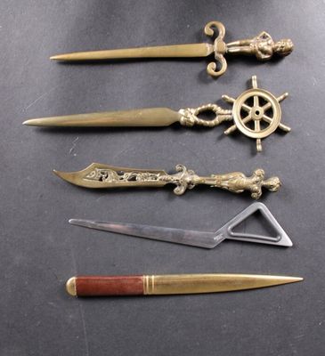 four different types of knives and a knife sharper on a table