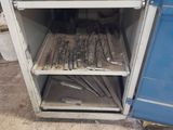 a small cabinet with tools on it in a room