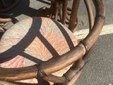 two wicker chairs and a table on the street