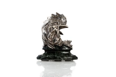 statue of a woman sitting on a rock with a bird in her hand