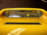 a yellow car parked in a garage with a brick wall in the background