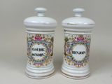 two ceramic jars that are sitting on a table