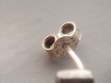 a pair of earrings that are sitting on a table