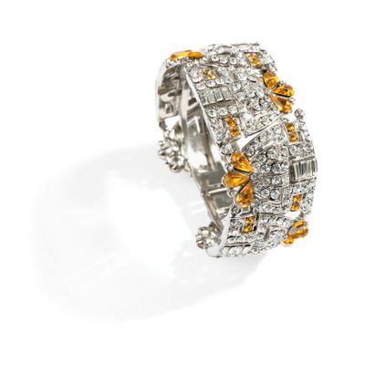 a close up of a ring with yellow and white diamonds