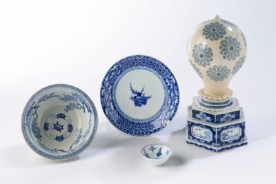 several blue and white plates and bowls on a white surface