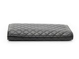 a black quilted purse on a white background
