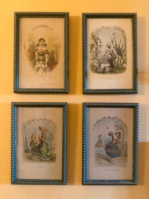 four framed pictures of a woman sitting on a bench in front of a yellow wall