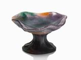 a glass bowl that is sitting on top of a table