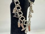 silver bracelet with charms and charms on a mannequin stand