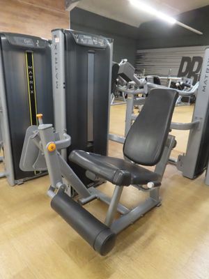 a gym room with a row of machines and other equipment