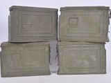 three old metal boxes stacked on top of each other on a white surface