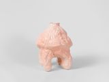 small pink ceramic figurine of a dog on a white background