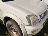 a picture of a white pick up truck parked in the grass