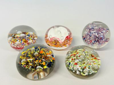 four glass marbles with sprinkles and sprinkles in them