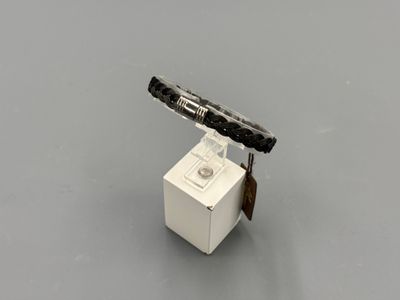 a small white box with a knife on top of it