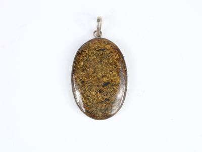 a close up of a brown stone pendant on a white surface