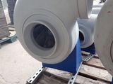 two exhaust fans sitting on a pallet in a warehouse