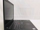 a black laptop computer sitting on a white surface