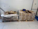 two pallets of cardboard sitting on a pallet in a room